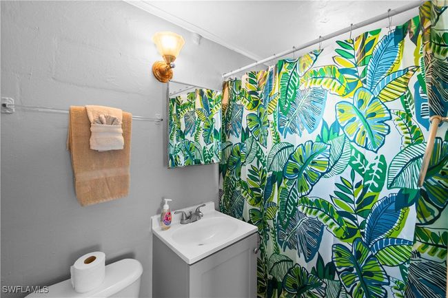 Bathroom featuring toilet, walk in shower, and vanity | Image 36