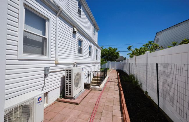 View of home's exterior featuring a cooling unit and a fenced backyard | Image 26