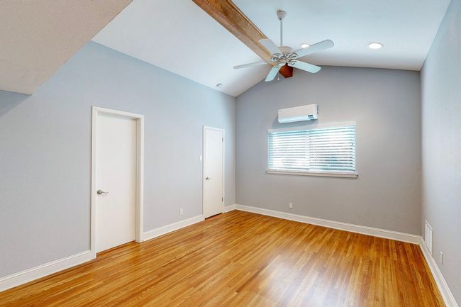 Bedroom with ceiling fan, a wall mounted AC, wood floors. B edroom with ceiling fan, mini-split AC | Image 16