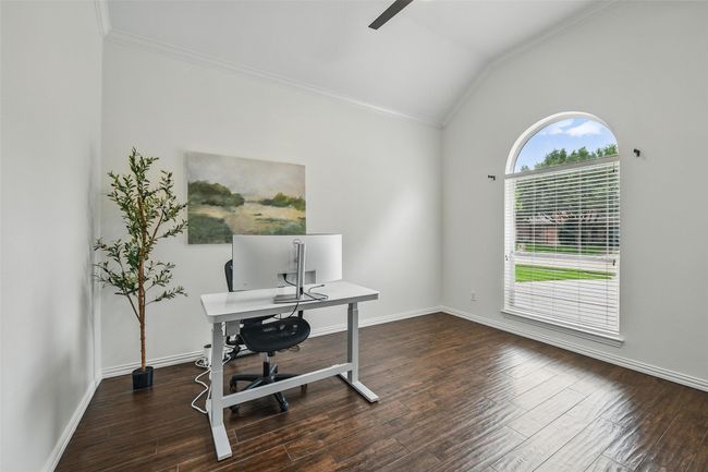 Office area with vaulted ceiling, crown molding, ceiling fan, and wood finished floors | Image 4