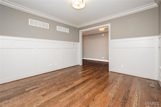Front room/den with ornamental molding, and a decorative wall | Image 7
