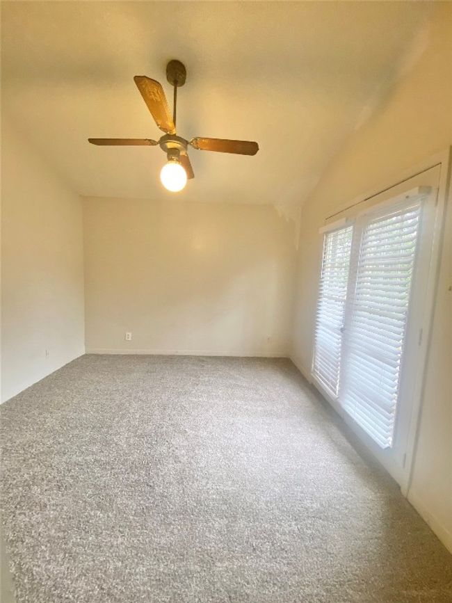 Unfurnished room featuring lofted ceiling, ceiling fan, and carpet floors | Image 8