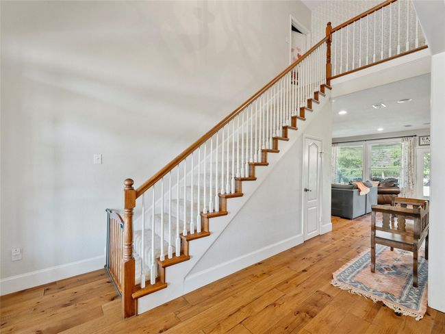 Stairway with hardwood / wood-style floors and a towering ceiling | Image 7