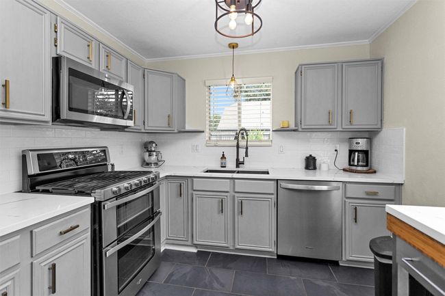 Kitchen was recently remodeled with Quartz counters and subway tile backsplash. The kitchen is also equipped with a gas stove, ideal for home cooks and culinary enthusiasts alike. | Image 8