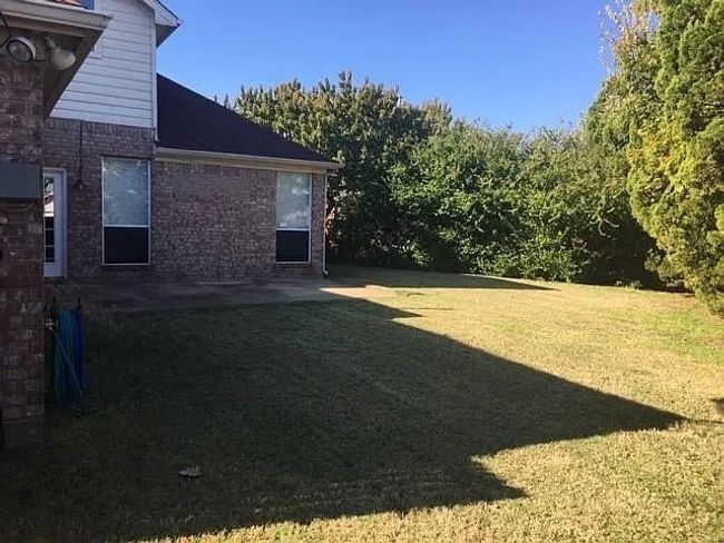 View of green lawn featuring a patio | Image 7