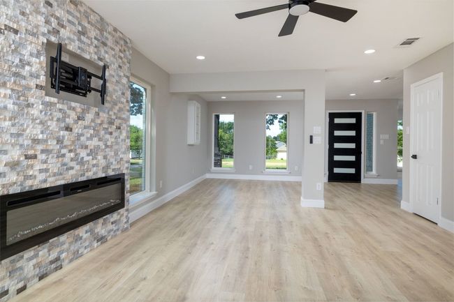 Unfurnished living room featuring wood finished floors, ceiling fan, and recessed lighting | Image 12