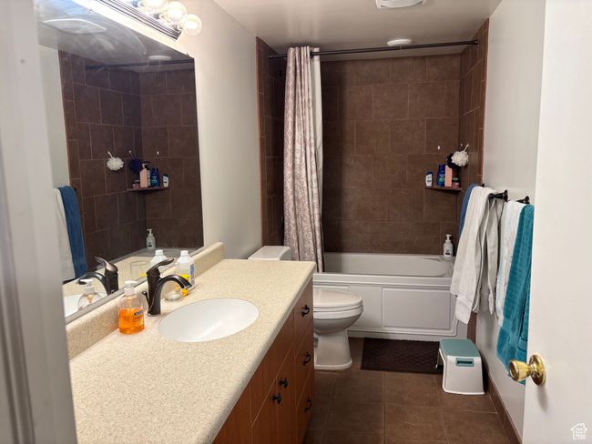Full bathroom featuring vanity, toilet, tile patterned flooring, and shower / tub combo | Image 18