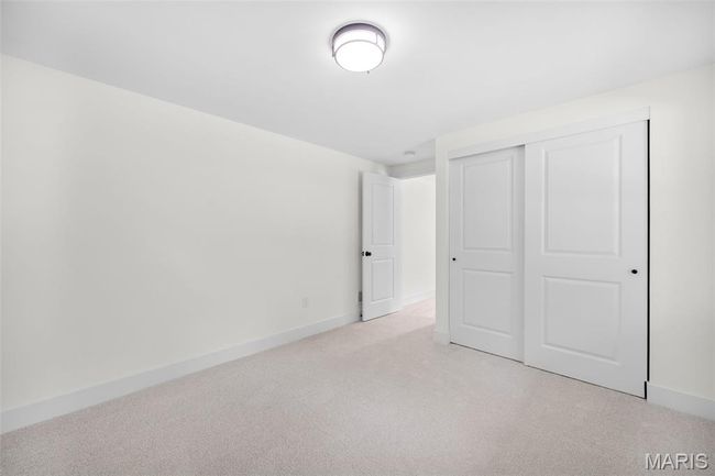 Unfurnished bedroom with light carpet and a closet | Image 42