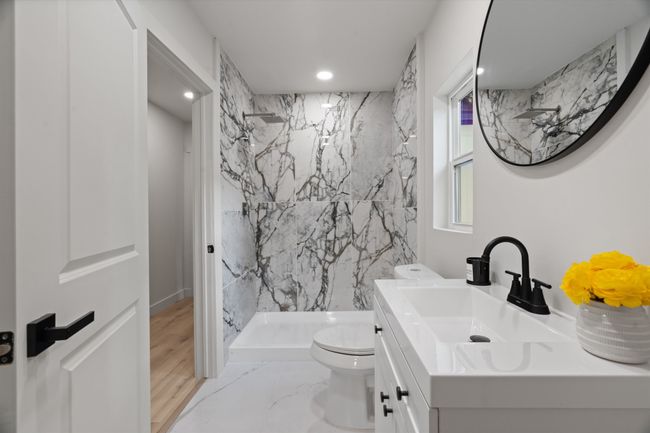 Full bathroom with a marble finish shower, toilet, vanity, and recessed lighting | Image 12