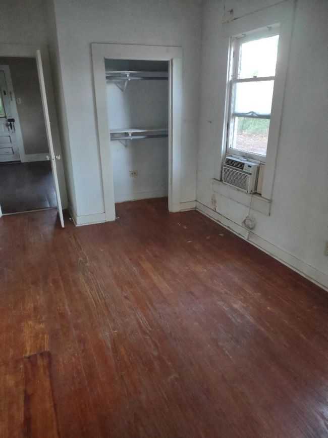 Unfurnished bedroom featuring baseboards, a closet, and wood-type flooring | Image 21