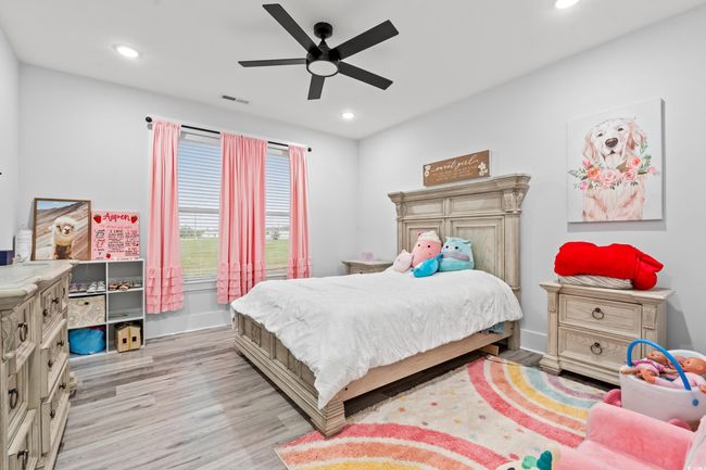 Bedroom with light wood-style flooring, recessed lighting, and a ceiling fan | Image 23