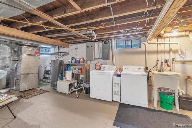 Unfinished basement with laundry and new appliances: furnace, hot water heater, water softener and iron filter. | Image 18