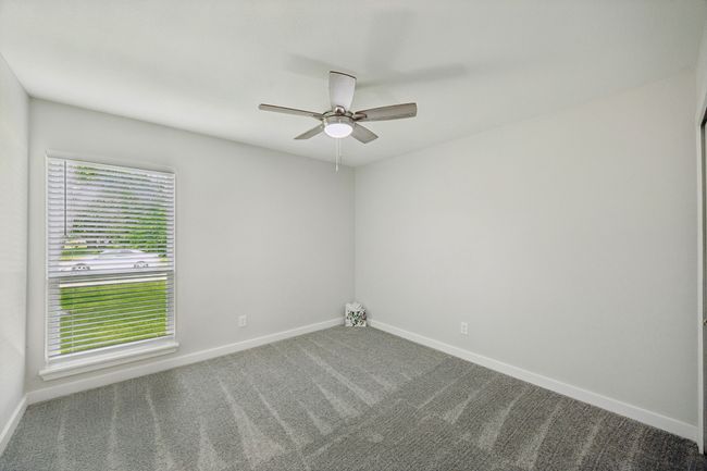 Bedroom two of the four bedrooms-love the new carpet and attractive ceiling fan - NEW windows throughout the home! | Image 31