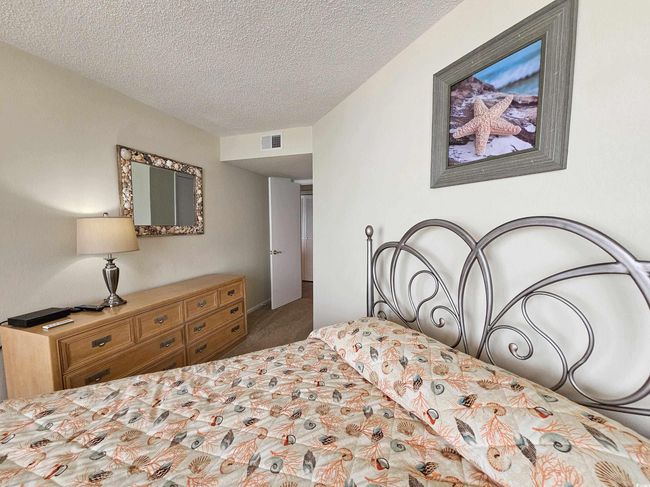 Bedroom featuring a textured ceiling and carpet floors | Image 31