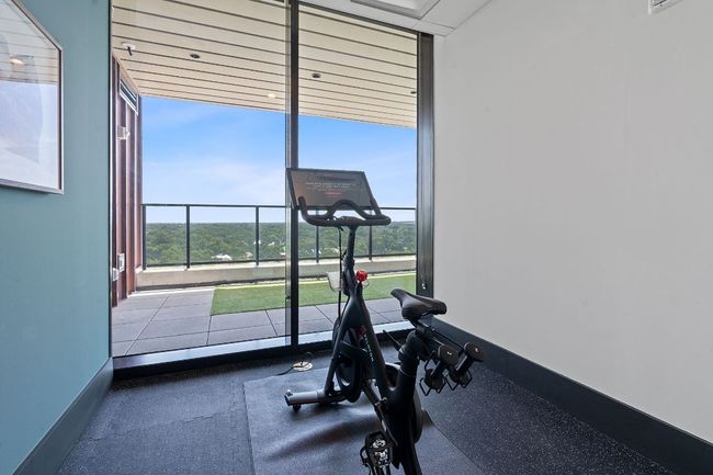 Workout area featuring a wall of windows and baseboards | Image 35