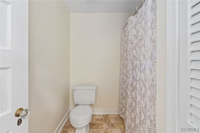 Full bathroom featuring toilet and baseboards | Image 13