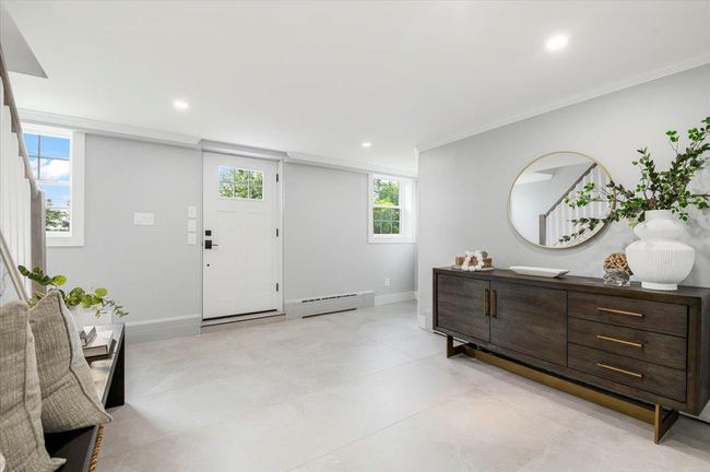 Entrance foyer featuring a baseboard heating unit, ornamental molding, recessed lighting, and healthy amount of natural light | Image 23