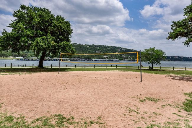 View of home's community with volleyball court and a water view | Image 23