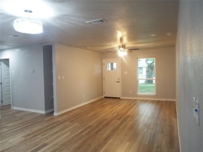 Unfurnished room featuring hardwood / wood-style floors and ceiling fan | Image 2