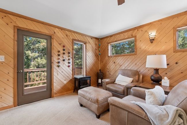 Upper level living room opening to upper level deck, featuring plenty of natural light. | Image 57