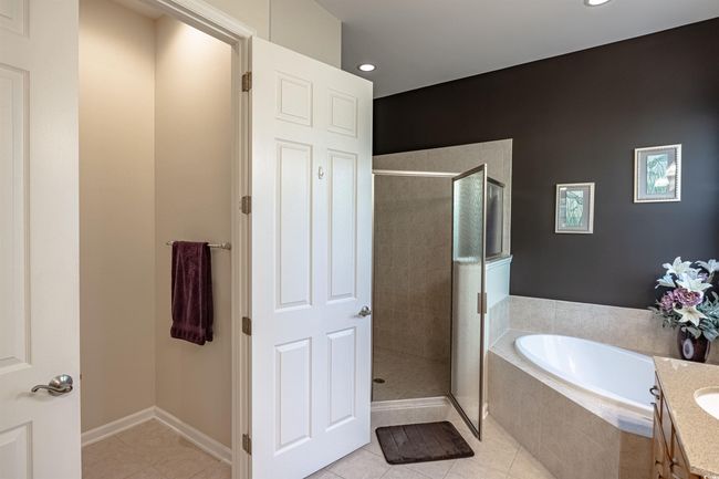 Bathroom featuring tile patterned flooring, vanity, and independent shower and bath | Image 30
