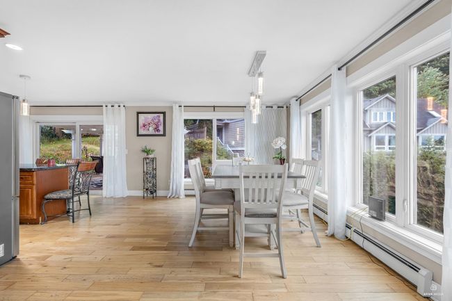 Dining space featuring light wood-type flooring, baseboards, and baseboard heating | Image 12