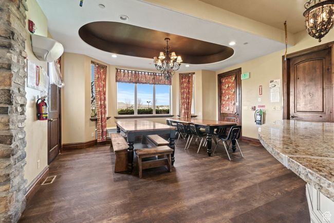 Dining space with visible vents, baseboards, a chandelier, and dark wood finished floors | Image 19