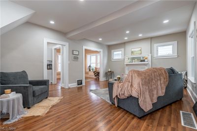 Living room featuring a wealth of natural light and dark wood-type flooring | Image 2