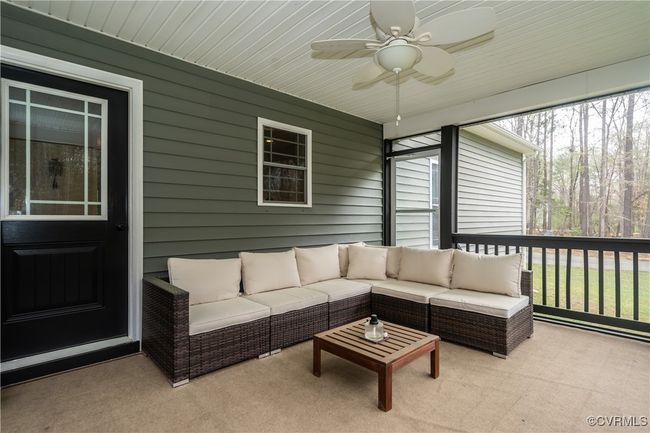 Sunroom featuring an outdoor living space and ceiling fan | Image 31
