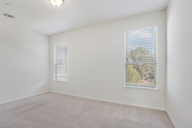 Empty room featuring light carpet, visible vents, and a wealth of natural light | Image 10