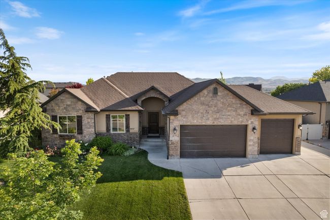 French country style house with a garage, driveway, a front lawn, stucco siding, and stone siding | Image 24