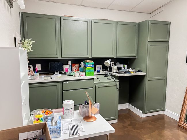 Kitchen with a drop ceiling, concrete floors, baseboards, light countertops, and green cabinetry | Image 14