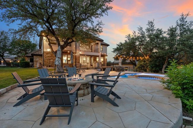 View of patio / terrace featuring a balcony, an outdoor fire pit, a jacuzzi, and an outdoor pool | Image 8