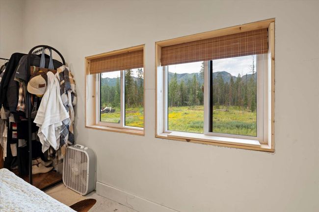 Bedroom with a view of trees and a mountain view | Image 33