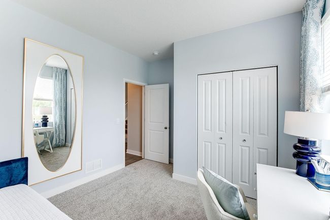 Another view of the main level bedroom. Photo of model home, color & options may vary. | Image 16