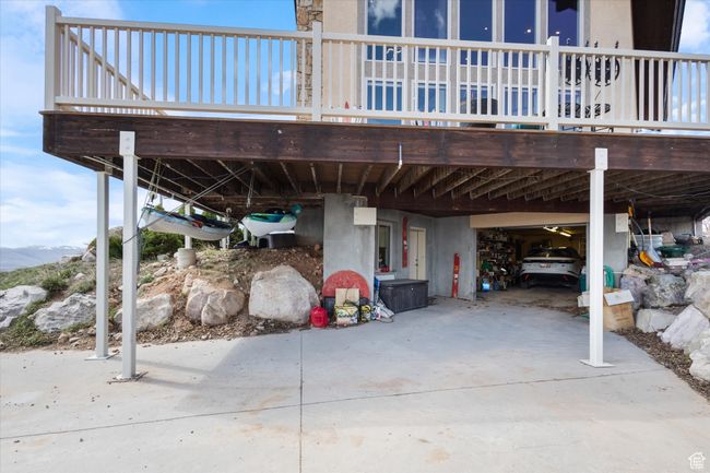 View of patio featuring a carport, a deck with mountain view, and concrete driveway | Image 22