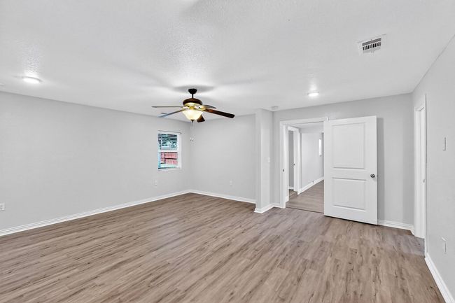 Spare room featuring a ceiling fan and wood finished floors | Image 29