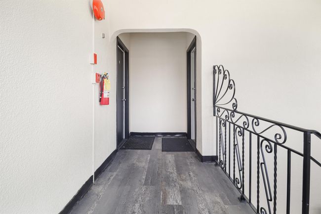 Hallway featuring arched walkways, dark wood-type flooring, and baseboards | Image 21