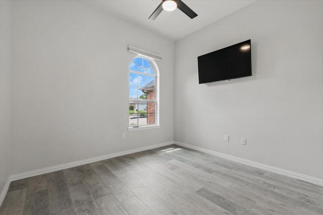 Empty room featuring wood finished floors, a ceiling fan, and baseboards | Image 28