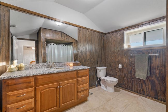 Bathroom with lofted ceiling, vanity, and a shower with curtain | Image 30