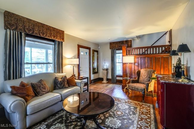 Living room with a wealth of natural light, wood finished floors, and baseboards | Image 10