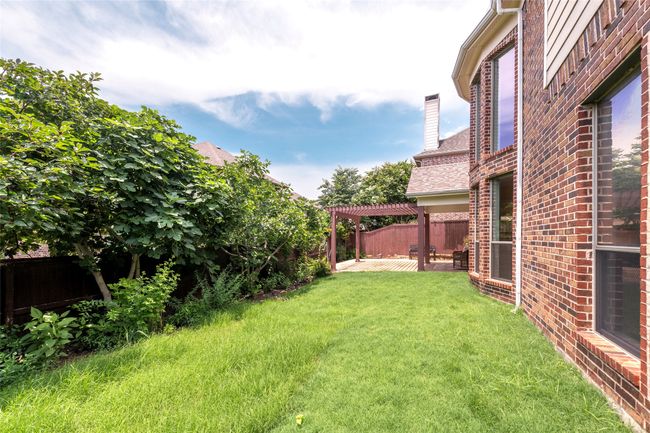 Fenced backyard with a pergola and a patio area | Image 40