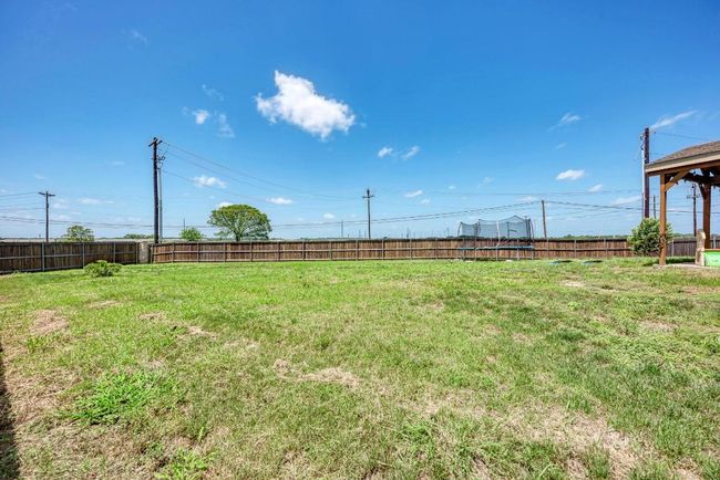 View of fenced backyard | Image 32