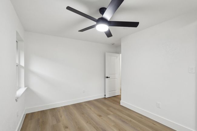 Spare room featuring baseboards, a ceiling fan, and light wood finished floors | Image 21