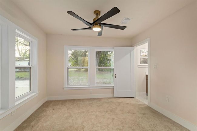 This versatile final bedroom is perfect as a mother-in-law suite, offering abundant natural light through large windows. | Image 31