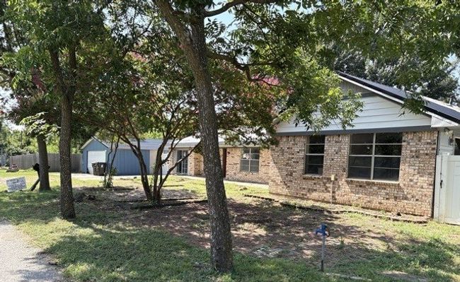 View of front of property featuring brick siding and a garage | Image 37