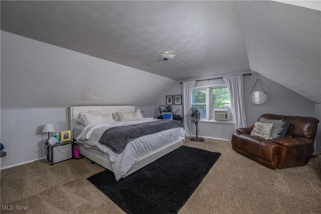 Carpeted bedroom with lofted ceiling and cooling unit | Image 15