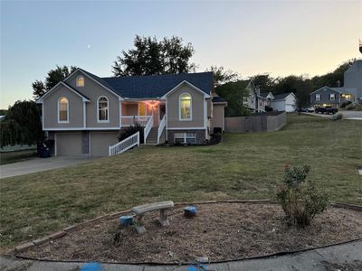 Split foyer home with a porch, a garage, and a lawn, Corner lot | Image 1