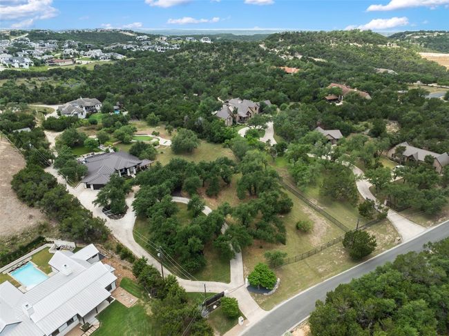 Automated gated entry. New Bermuda grass and flower beds planted in circular drive and front gate area. Crushed limestone road to the extra storage 300 sf building at the back of the property that has electricity connected and water access nearby. Plus, 200 feet of new fencing was added between neighborhood road and the property. | Image 37