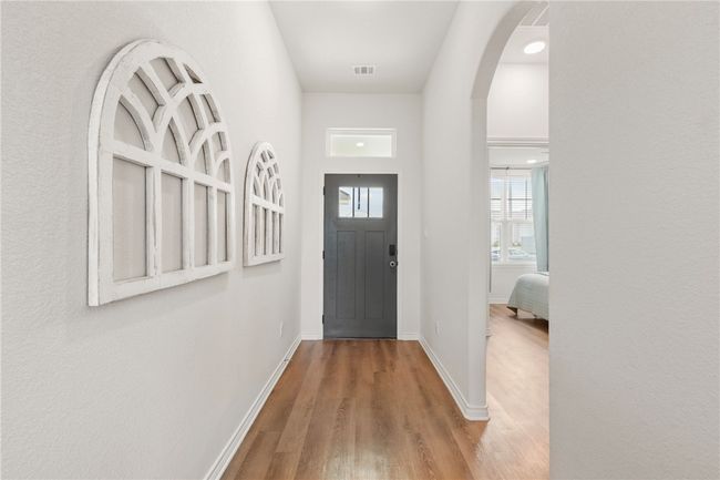 Foyer featuring wood finished floors and arched walkways | Image 5